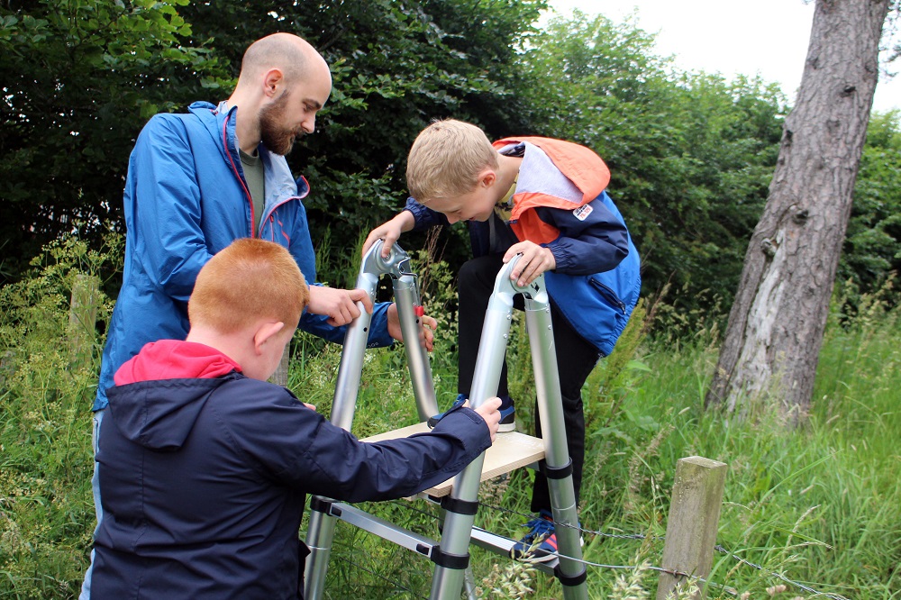 Pupils from Newfield Primary School enjoy use of the backpack ladder with Project Officer Michael